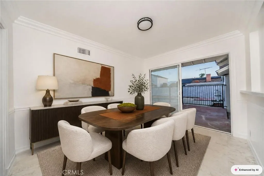 Virtually staged dining room next to patio.