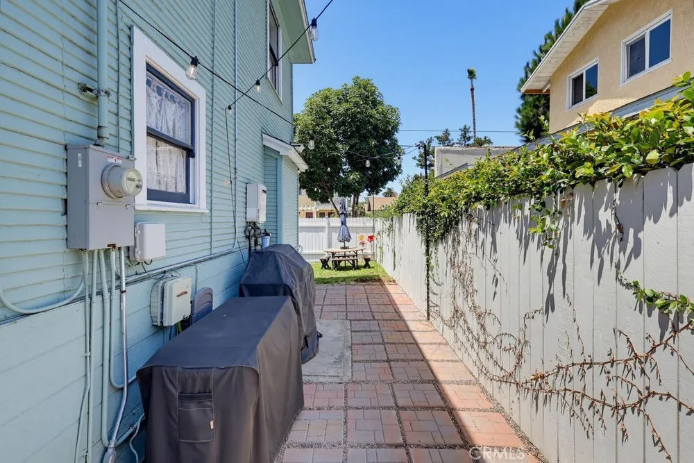 Walkway to side yard off kitchen. Space for outdoor cooking.