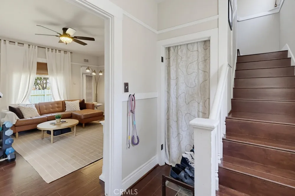 Living room, storage closet and stairs.