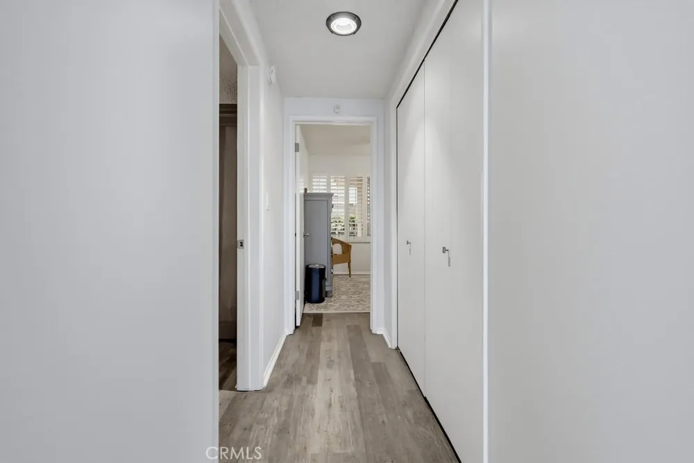Hall with laundry closet leading to two bedrooms Hall with laundry closet leading to two bedrooms