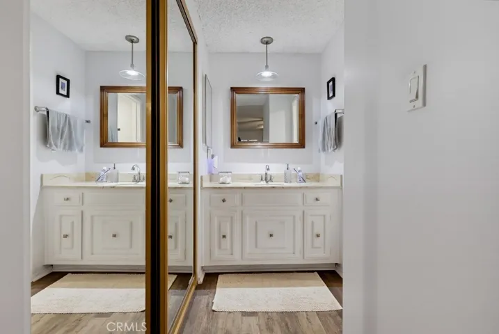 Primary closet looking to bath vanity area

