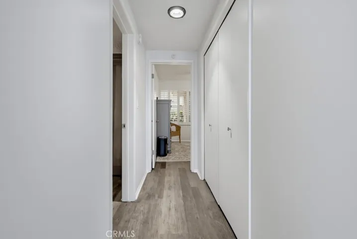 Hall with laundry closet leading to two bedrooms