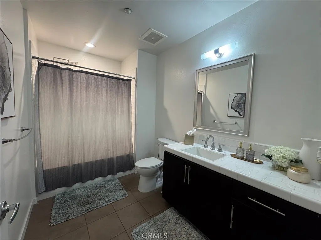 Bath room # 3 with a shower in the bath