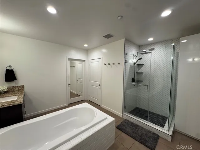 Full size bath tub and a his and hers sinks.
