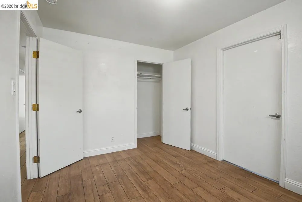 Wood-finish flooring with white baseboards