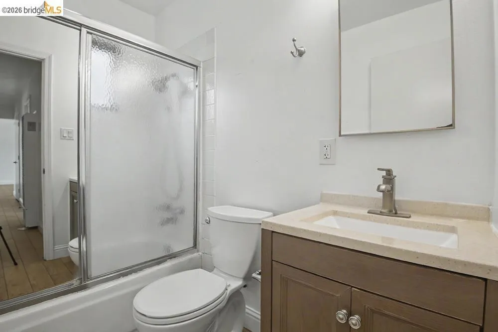 Contemporary bathroom featuring a vanity with a light-toned countertop, an undermount sink, and a brushed nickel faucet