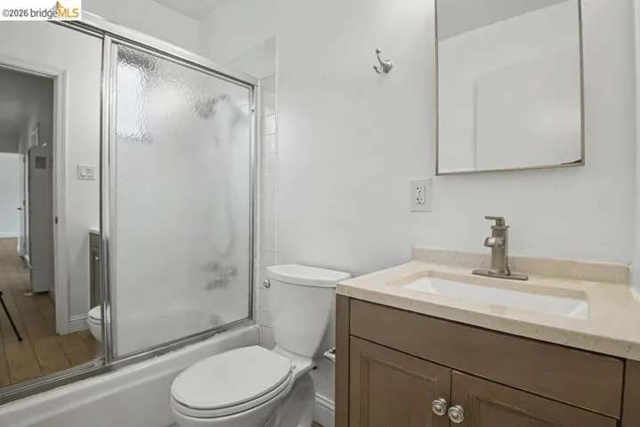 Contemporary bathroom featuring a vanity with a light-toned countertop, an undermount sink, and a brushed nickel faucet