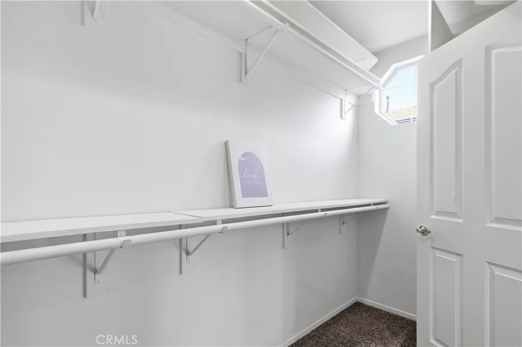 Walk in closet in primary bedroom