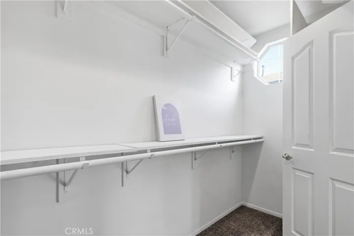 Walk in closet in primary bedroom