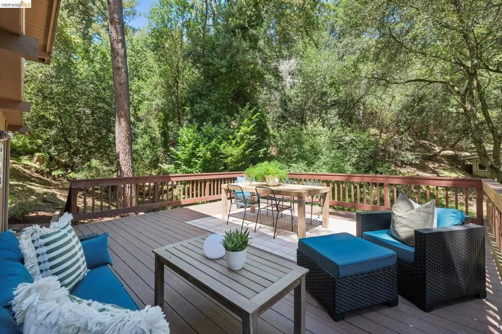 Expansive wood-finish deck with a wood railing, offering a private outdoor setting