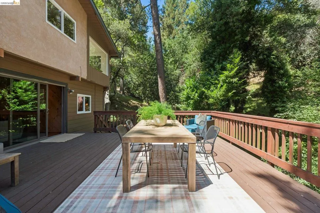 Expansive outdoor deck featuring wood flooring and a perimeter railing