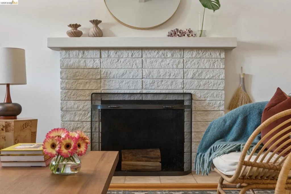 Fireplace with a stone block surround and a hearth screen