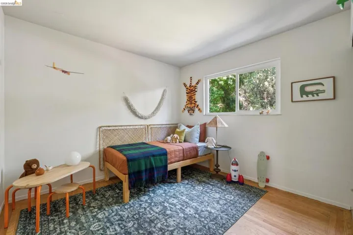 Hardwood flooring, white walls, and a large window