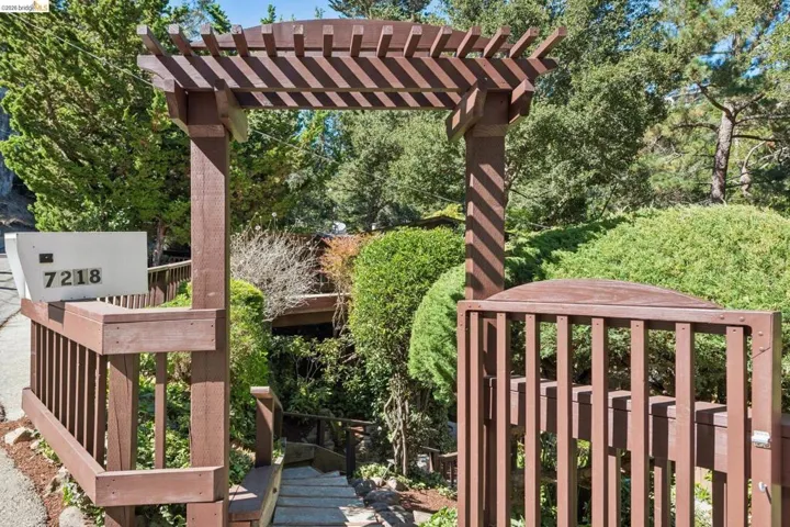 Wood-finish pergola and gate entry with an integrated mailbox