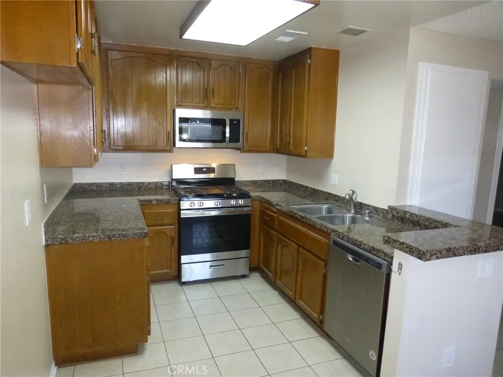 Upgraded kitchen with stainless appliances and marble countertops