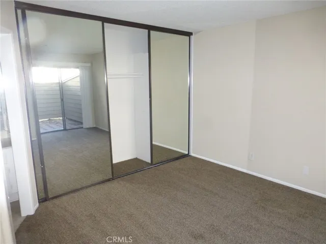 Primary closet with mirrored doors