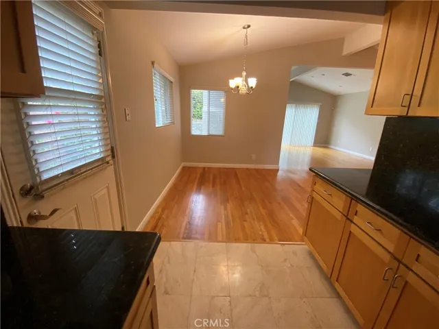Kitchen open to dinning area and door to backyard