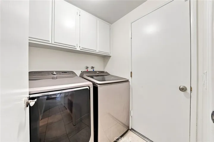  The main level includes an interior laundry room with built-in cabinetry for additional convenience.