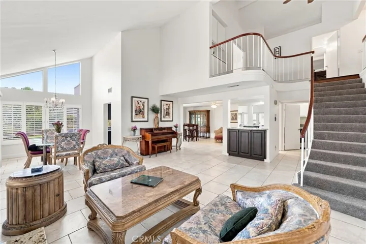 This light and bright home welcomes you through a double-door entry into the spacious formal living room with dramatic two-story vaulted ceilings. Fresh new interior paint