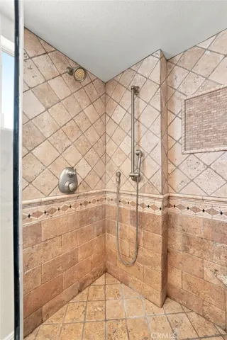 The upgraded primary bath features a large custom finished walk-in shower with glass enclosure.