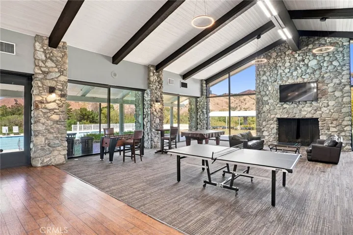 A large clubhouse featuring soaring ceilings, a fireplace and full kitchen for your events.