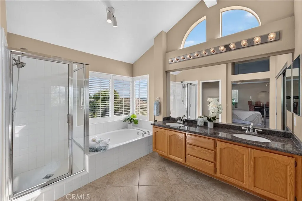 Primary Bathroom has it ALL. Dual Sinks, Large Tub, Shower, Plantation Shutters, tile Floor