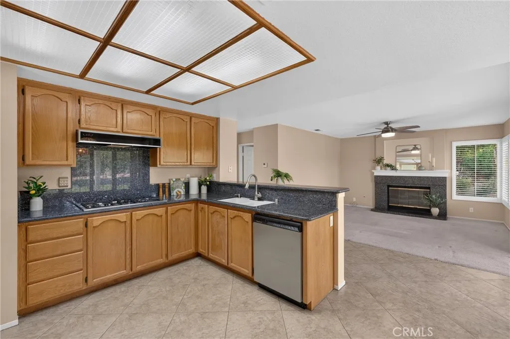 View to the Family Room.  Coordinated Granite in Kitchen and Fireplace