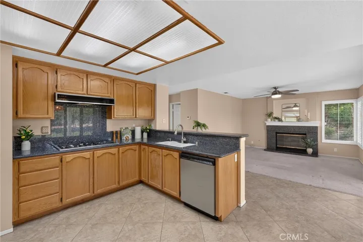 View to the Family Room.  Coordinated Granite in Kitchen and Fireplace