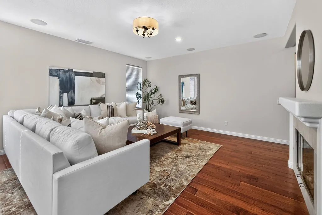 Rich hard wood floors connect the kitchen, casual living, and entry