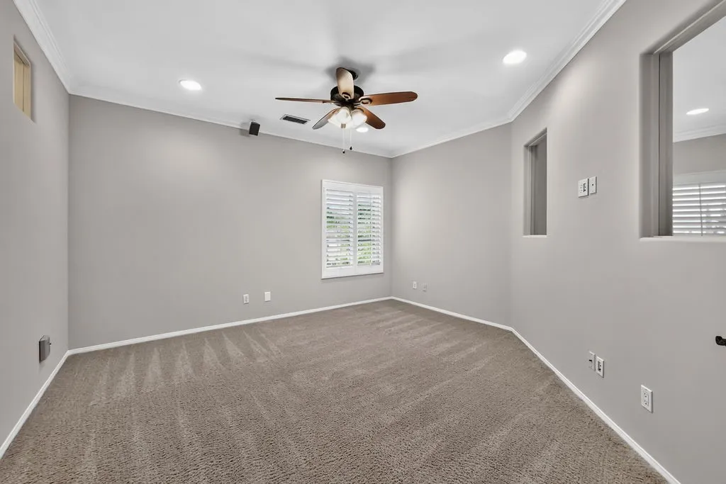 Large bedroom with double glass doors at the top of the stairs