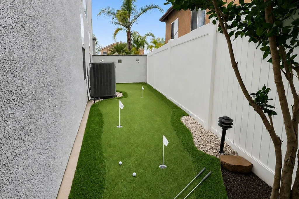 AI enhanced putting green adjacent to the outdoor kitchen
