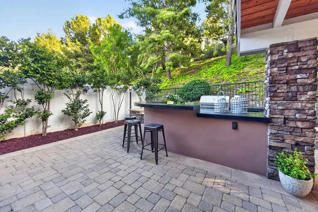 Spacious stone outdoor kitchen and bar
