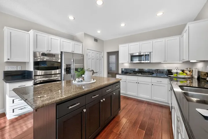 Ample cabinetry and double door pantry adjacent to dining toom