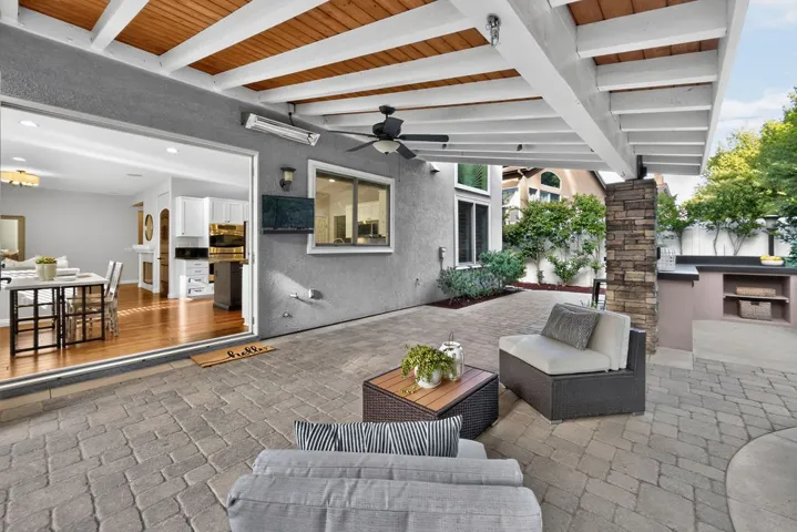 Gorgeous wood beamed covered living area