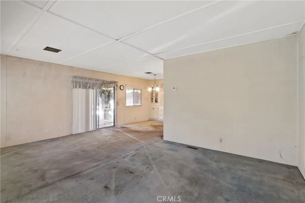 Living Room with view of dining area and slider out to patio