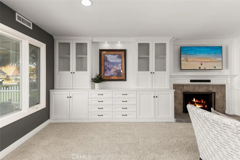 The family room features built-in cabinets and a fireplace.