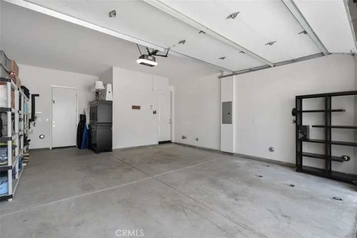 An oversized two-car garage provides additional storage space and convenient side-door access to the yard.