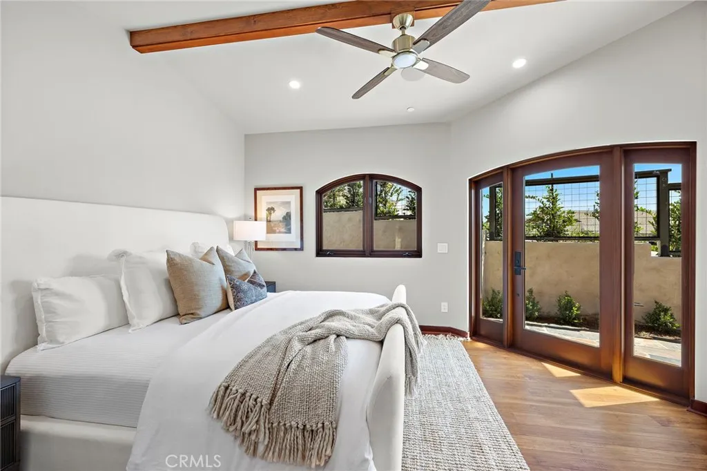 Primary bedroom with reclaimed Honduras Mahogany windows and door Primary bedroom with reclaimed Honduras Mahogany windows and door