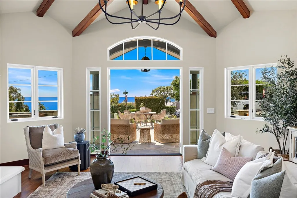 French doors lead from the living room to the front patio with breathtaking views, creating an inviting connection between the interior and outdoor living spaces. French doors lead from the living room to the front patio with breathtaking views, creating an inviting connection between the interior and outdoor living spaces.