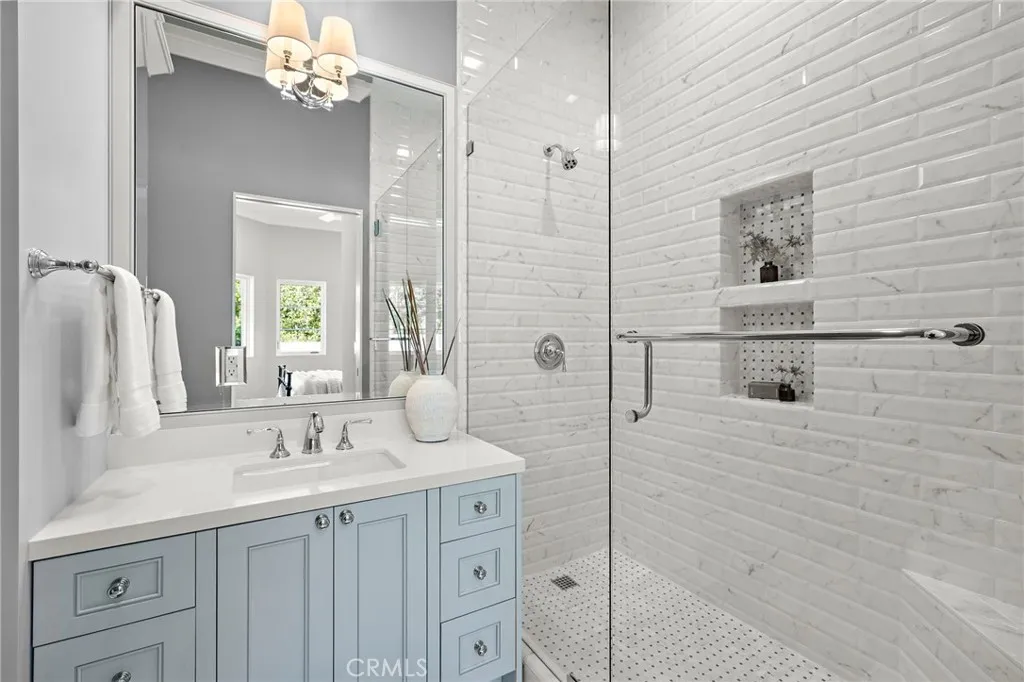 En-suite bath to guest bedroom one with Toto toilet, Phylrich faucets, and white Quartz countertops. Shower features Carrera basketweave and Ceramica Carrera. En-suite bath to guest bedroom one with Toto toilet, Phylrich faucets, and white Quartz countertops. Shower features Carrera basketweave and Ceramica Carrera.