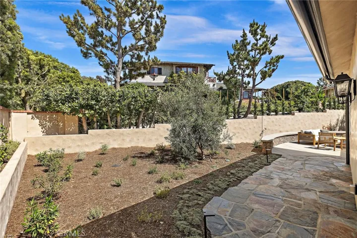 Backyard and back patio area is fully fenced, landscaped, and hardscaped.