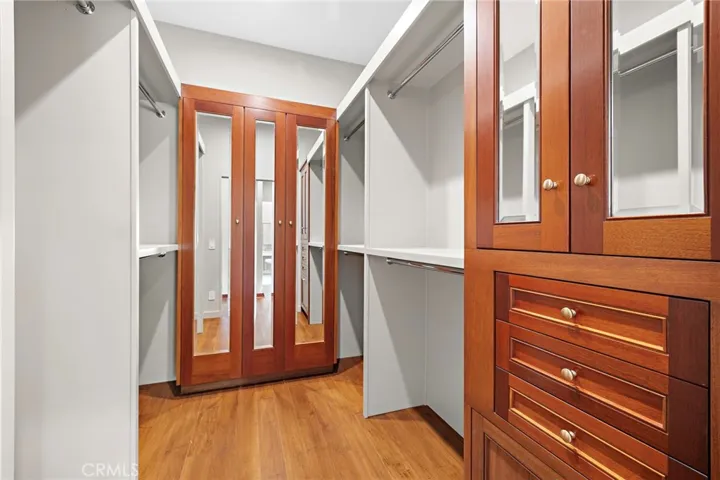 Primary walk-in closet finished in reclaimed Honduras Mahogany