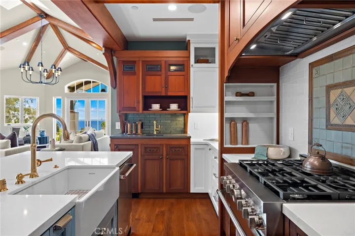 A dedicated bar with custom cabinetry, quartz counters, and a Soft Tetris tile backsplash creates a natural setting for entertaining.