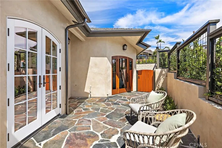 Door from the primary suite leads to an exterior sitting area.
