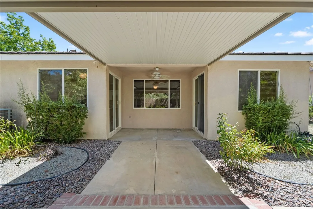 View from covered patio to rear of home. Patio doors shown are to guest bedroom #2 and kichen. View from covered patio to rear of home. Patio doors shown are to guest bedroom #2 and kichen.