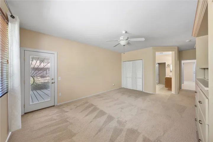 Primary suite with two closets and an exterior door to private covered patio