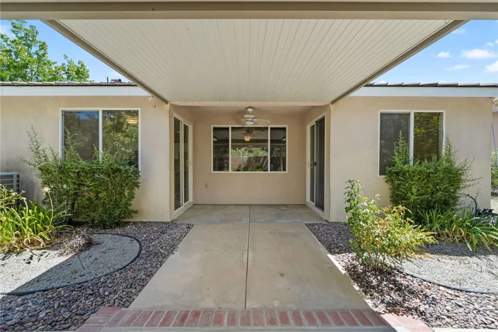 View from covered patio to rear of home. Patio doors shown are to guest bedroom #2 and kichen.