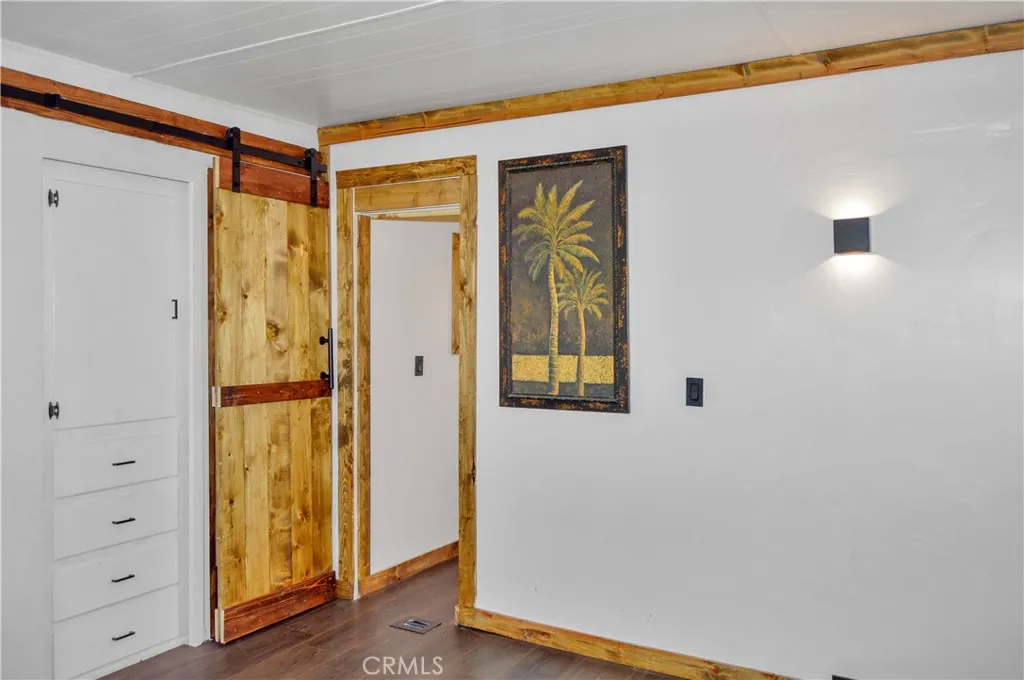 The Main Bedroom Next Door has a Barn Door Entry, Modern Lighting, Dual Closets with Drawers Below, and More Storage Hidden Behind the Barn Door The Main Bedroom Next Door has a Barn Door Entry, Modern Lighting, Dual Closets with Drawers Below, and More Storage Hidden Behind the Barn Door