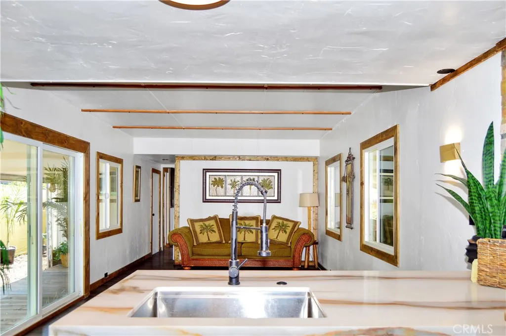 Big, Beautiful Kitchen with New Cabinetry, Quartz Countertops, Stainless Steel Sink with Sprayer, Stainless Steel and Black Range, Wood and Stone Accents, Custom Lighting, Black Hardware, and a Wood-Trimmed Refrigerator Big, Beautiful Kitchen with New Cabinetry, Quartz Countertops, Stainless Steel Sink with Sprayer, Stainless Steel and Black Range, Wood and Stone Accents, Custom Lighting, Black Hardware, and a Wood-Trimmed Refrigerator