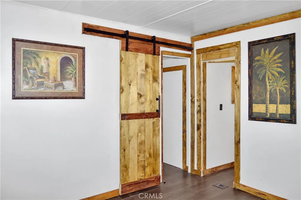 The Main Bedroom Next Door has a Barn Door Entry, Modern Lighting, Dual Closets with Drawers Below, and More Storage Hidden Behind the Barn Door The Main Bedroom Next Door has a Barn Door Entry, Modern Lighting, Dual Closets with Drawers Below, and More Storage Hidden Behind the Barn Door